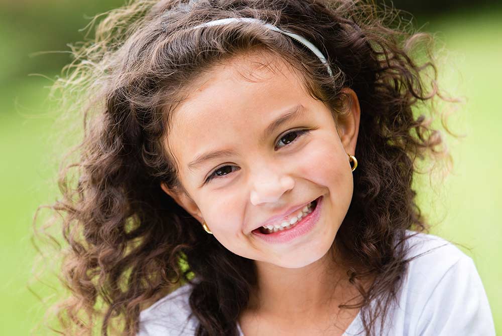 Smiling little girl with curly hair