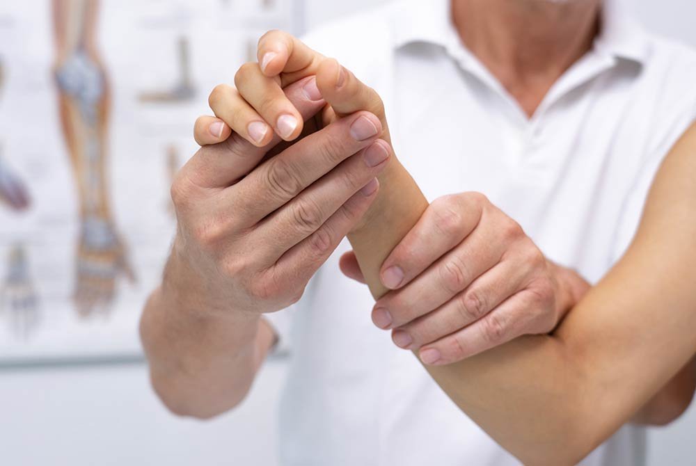 woman receiving physical therapy on wrist